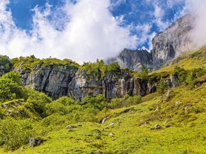 Preview wallpaper cliff, rock, grass, clouds