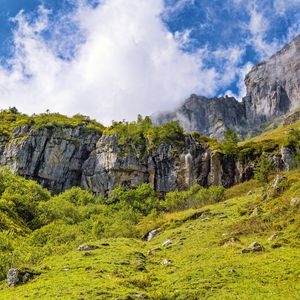 Preview wallpaper cliff, rock, grass, clouds