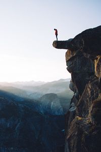 Preview wallpaper cliff, rock, man, mountains, height