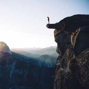 Preview wallpaper cliff, rock, man, mountains, height