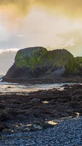 Preview wallpaper cliff, rocks, coast, sunset, sky