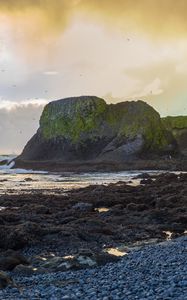 Preview wallpaper cliff, rocks, coast, sunset, sky