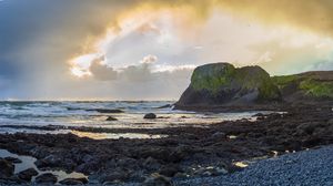 Preview wallpaper cliff, rocks, coast, sunset, sky