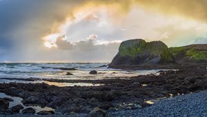 Preview wallpaper cliff, rocks, coast, sunset, sky