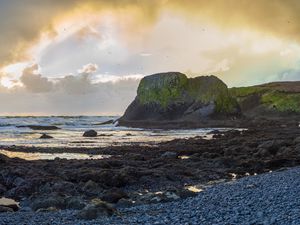 Preview wallpaper cliff, rocks, coast, sunset, sky