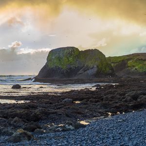 Preview wallpaper cliff, rocks, coast, sunset, sky