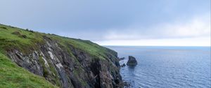 Preview wallpaper cliff, rocks, sea, horizon, stones