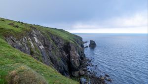 Preview wallpaper cliff, rocks, sea, horizon, stones