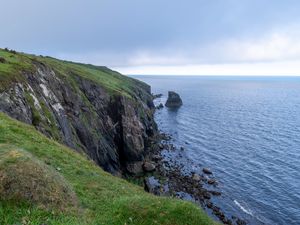 Preview wallpaper cliff, rocks, sea, horizon, stones