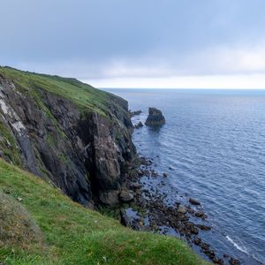 Preview wallpaper cliff, rocks, sea, horizon, stones