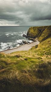 Preview wallpaper cliff, sea, coast, grass, beach, landscape