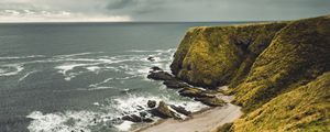 Preview wallpaper cliff, sea, coast, grass, beach, landscape