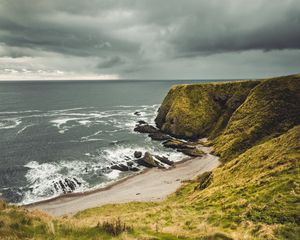 Preview wallpaper cliff, sea, coast, grass, beach, landscape