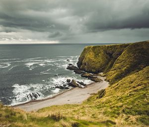 Preview wallpaper cliff, sea, coast, grass, beach, landscape