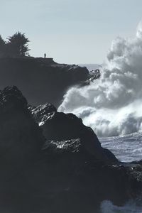 Preview wallpaper cliff, silhouette, alone, sea, waves, storm