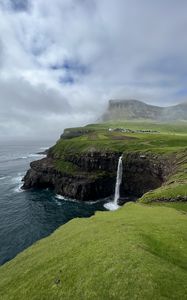 Preview wallpaper cliff, waterfall, sea, grass, fog