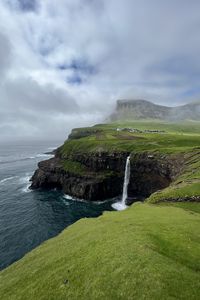 Preview wallpaper cliff, waterfall, sea, grass, fog