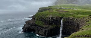 Preview wallpaper cliff, waterfall, sea, grass, fog