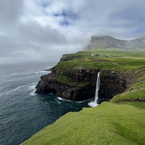 Preview wallpaper cliff, waterfall, sea, grass, fog