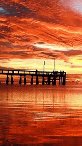 Preview wallpaper clouds, decline, evening, sky, orange, structure, pier, people, bridge, sea