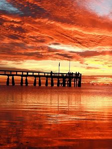 Preview wallpaper clouds, decline, evening, sky, orange, structure, pier, people, bridge, sea