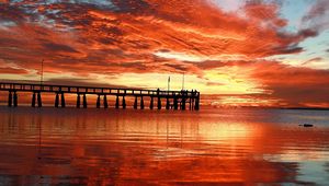 Preview wallpaper clouds, decline, evening, sky, orange, structure, pier, people, bridge, sea