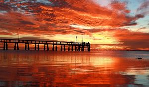 Preview wallpaper clouds, decline, evening, sky, orange, structure, pier, people, bridge, sea