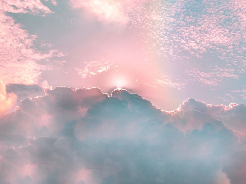 The Rainbow sky is Colorful sky with Soft clouds and a rainbow crossing.  Fantasy magical sunny sky pastel background is fluffy white cloud. Freedom  wallpaper concept. Sweet color dream. Stock Photo |