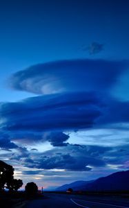 Preview wallpaper clouds, road, night, curls, mountains