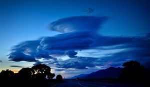 Preview wallpaper clouds, road, night, curls, mountains
