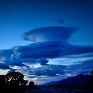Preview wallpaper clouds, road, night, curls, mountains
