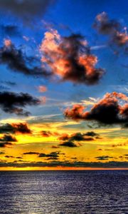 Preview wallpaper clouds, sea, sky, evening, shadows, yellow, dark blue, colors