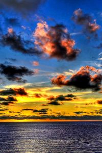 Preview wallpaper clouds, sea, sky, evening, shadows, yellow, dark blue, colors