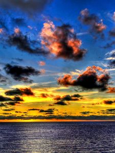 Preview wallpaper clouds, sea, sky, evening, shadows, yellow, dark blue, colors