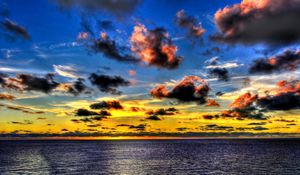 Preview wallpaper clouds, sea, sky, evening, shadows, yellow, dark blue, colors