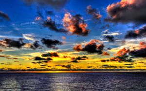 Preview wallpaper clouds, sea, sky, evening, shadows, yellow, dark blue, colors