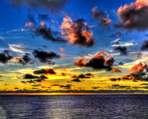 Preview wallpaper clouds, sea, sky, evening, shadows, yellow, dark blue, colors