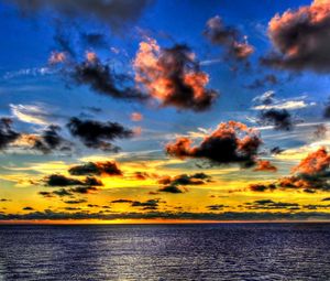 Preview wallpaper clouds, sea, sky, evening, shadows, yellow, dark blue, colors