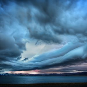 Preview wallpaper clouds, sky, gloomy, blackness, sea, smooth surface