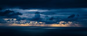 Preview wallpaper clouds, sky, rays, sea, dark