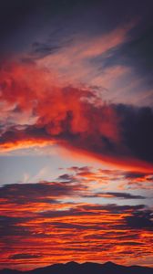 Preview wallpaper clouds, sky, sunset, red, porous, mountains, fiery