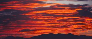 Preview wallpaper clouds, sky, sunset, red, porous, mountains, fiery