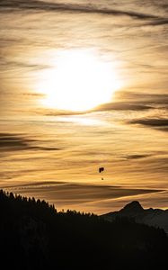 Preview wallpaper clouds, sky, trees, mountains, paraglider, silhouettes, twilight