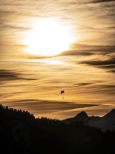 Preview wallpaper clouds, sky, trees, mountains, paraglider, silhouettes, twilight