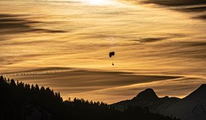 Preview wallpaper clouds, sky, trees, mountains, paraglider, silhouettes, twilight