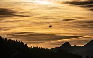 Preview wallpaper clouds, sky, trees, mountains, paraglider, silhouettes, twilight