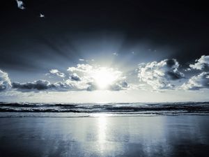 Preview wallpaper coast, beach, sun, clouds, beams, sand, black-and-white