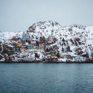 Preview wallpaper coast, buildings, cliff, mountains, snow