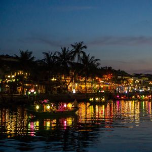 Preview wallpaper coast, buildings, lights, water, boats, dark