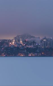 Preview wallpaper coast, city, buildings, clouds, dusk